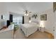 Bedroom area with hardwood floors, a bed, and sitting chair at 3035 Countryside Blvd # 16B, Clearwater, FL 33761