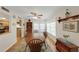 A lovely dining room featuring wood floors, a wood table, and an area rug at 3035 Countryside Blvd # 16B, Clearwater, FL 33761