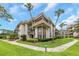 Inviting condo building with well-manicured lawn, lovely greenery, and mature palm trees at 3035 Countryside Blvd # 16B, Clearwater, FL 33761