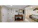 A lovely home foyer with neutral tones, tiled floors, and a decorative wooden console table at 3035 Countryside Blvd # 16B, Clearwater, FL 33761