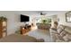 Bright living room featuring a ceiling fan, hardwood floors, and sliding glass doors at 3035 Countryside Blvd # 16B, Clearwater, FL 33761
