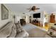 Spacious living room with neutral color palette, ceiling fan, and hardwood flooring at 3035 Countryside Blvd # 16B, Clearwater, FL 33761