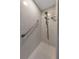 Shower featuring tile walls, a handrail, and dual shower heads at 3035 Countryside Blvd # 16B, Clearwater, FL 33761