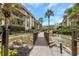 Beautiful community water feature with lush landscaping and bridge walkway, creating a serene environment at 3035 Countryside Blvd # 16B, Clearwater, FL 33761