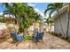 Private backyard featuring tropical landscaping, a brick patio, and comfortable seating areas at 3173 Fountainhead Dr, Largo, FL 33770