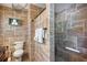 Stylish bathroom with tiled walls, a modern toilet, and glass-enclosed shower with seating at 3173 Fountainhead Dr, Largo, FL 33770