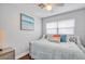 Bright bedroom featuring a stylish daybed, ceiling fan, and beach-themed artwork at 3173 Fountainhead Dr, Largo, FL 33770