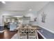 Stylish dining area adjacent to the living room with hardwood floors and modern decor at 3173 Fountainhead Dr, Largo, FL 33770