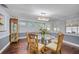 Charming dining room with glass table, wood chairs, and decorative china cabinet at 3173 Fountainhead Dr, Largo, FL 33770