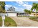 Charming single-story home with a well-manicured lawn, long driveway, and a two-car garage at 3173 Fountainhead Dr, Largo, FL 33770