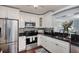 Modern kitchen with stainless steel appliances, granite counters, and mosaic backsplash at 3173 Fountainhead Dr, Largo, FL 33770