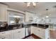 Bright kitchen featuring granite countertops, stainless steel appliances, and wooden flooring at 3173 Fountainhead Dr, Largo, FL 33770