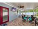 Beautiful lanai with brick floors, comfortable seating, a television, and great views of the backyard at 3173 Fountainhead Dr, Largo, FL 33770