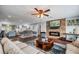 Comfortable living area featuring a stone fireplace, ceiling fan, and hardwood floors at 3173 Fountainhead Dr, Largo, FL 33770
