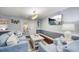 Inviting living room with comfortable blue couches and a view to an outdoor space at 3173 Fountainhead Dr, Largo, FL 33770