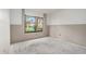 A bedroom under construction offers a large window with a street view, visible wall framework, and concrete flooring at 326 Moorings Cove Dr # 2B, Tarpon Springs, FL 34689
