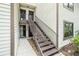 Exterior view showcasing the stairway leading to the upper-level entrances, highlighting the inviting design at 326 Moorings Cove Dr # 2B, Tarpon Springs, FL 34689