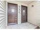 Up-close exterior view of the upper-level condo entrances with unit numbers and decorative details at 326 Moorings Cove Dr # 2B, Tarpon Springs, FL 34689