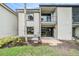 Back exterior of a home with patio, canal view, and an AC unit at 326 Moorings Cove Dr # 2B, Tarpon Springs, FL 34689