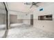 Living room showcasing glass doors, window, and view to kitchen at 326 Moorings Cove Dr # 2B, Tarpon Springs, FL 34689