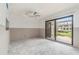 Living room highlighting sliding glass doors, natural light, and open layout at 326 Moorings Cove Dr # 2B, Tarpon Springs, FL 34689
