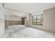 Spacious living room with large window and sliding glass doors allowing lots of natural light at 326 Moorings Cove Dr # 2B, Tarpon Springs, FL 34689