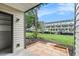 Back patio overlooking a canal, a green lawn, and boat parking, offering peaceful outdoor living at 326 Moorings Cove Dr # 2B, Tarpon Springs, FL 34689