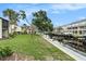 Scenic waterfront view featuring a canal with boat docks and lush green landscaping surrounding the residences at 326 Moorings Cove Dr # 2B, Tarpon Springs, FL 34689