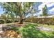 A well-maintained backyard features a lush lawn, mature trees, and a charming wooden fence at 3652 18Th N Ave, St Petersburg, FL 33713