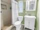 Bright bathroom featuring a walk-in shower with tiled surround, toilet, and vanity with storage at 3652 18Th N Ave, St Petersburg, FL 33713