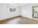 Bright bedroom with wood flooring, large window, and attached bathroom at 3652 18Th N Ave, St Petersburg, FL 33713