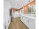 Bright kitchen with white cabinets, modern appliances, and light wood flooring at 3652 18Th N Ave, St Petersburg, FL 33713