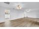 Bright, open living space with light wood flooring and multiple ceiling fans at 3652 18Th N Ave, St Petersburg, FL 33713