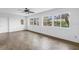 Bright living room featuring wood floors and large windows offering a serene outdoor view at 3652 18Th N Ave, St Petersburg, FL 33713