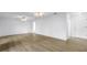Expansive living area with light wood flooring, ceiling fans, and a white front door at 3652 18Th N Ave, St Petersburg, FL 33713