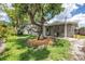 A backyard with mature trees, a patio, and outdoor decor, enhancing the property's appeal and functionality at 3652 18Th N Ave, St Petersburg, FL 33713