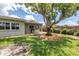 An expansive backyard, complete with mature trees, covered patio, and storage, providing ample outdoor enjoyment at 3652 18Th N Ave, St Petersburg, FL 33713