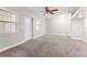 Spacious bedroom with neutral carpet, ample natural light, and a ceiling fan for comfort and style at 3753 Thornbush Ln, New Port Richey, FL 34655