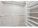 Walk-in closet featuring ample shelving and rods for maximum storage and organization at 3753 Thornbush Ln, New Port Richey, FL 34655