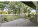Spacious back deck with lovely wooden railing overlooking beautiful green landscape at 3753 Thornbush Ln, New Port Richey, FL 34655