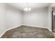 Well-lit dining area features stylish tile flooring and a modern chandelier, creating a welcoming atmosphere at 3753 Thornbush Ln, New Port Richey, FL 34655
