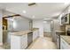 Open kitchen showcases granite countertops, stainless steel appliances, and seamless flow into the living area at 3753 Thornbush Ln, New Port Richey, FL 34655