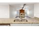 Gourmet kitchen overlooking the spacious living room with its stunning stone fireplace and wooden beam at 3753 Thornbush Ln, New Port Richey, FL 34655