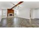 Bright living room features a striking stone fireplace, vaulted ceiling, and stylish tile flooring throughout at 3753 Thornbush Ln, New Port Richey, FL 34655