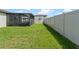 The fenced backyard provides a great space with a screened patio at 39024 Harlow Rose Dr, Zephyrhills, FL 33540