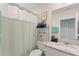 Bright bathroom featuring a granite vanity, a mirror, a toilet, and a shower with a curtain at 39024 Harlow Rose Dr, Zephyrhills, FL 33540
