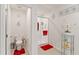 Cozy bathroom features a toilet room to the left and an all-tile shower with red accents to the right at 39024 Harlow Rose Dr, Zephyrhills, FL 33540