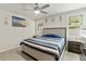 Cozy bedroom with a queen bed, ceiling fan, and windows providing natural light at 39024 Harlow Rose Dr, Zephyrhills, FL 33540