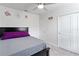 Comfortable bedroom featuring carpeted floors, floral decals, and closet doors at 39024 Harlow Rose Dr, Zephyrhills, FL 33540