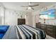 Well-decorated bedroom with a large bed, dark wooden dressers, and a TV on the wall at 39024 Harlow Rose Dr, Zephyrhills, FL 33540